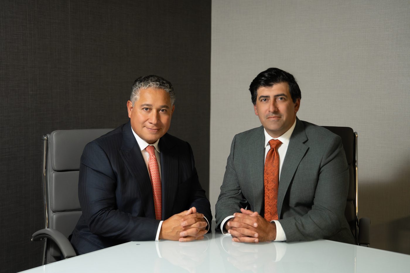 Founding partners Douglas V. Sanchez and Michael J. Maselli seated at a conference table